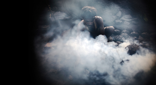 A man burns coal in Jharia.