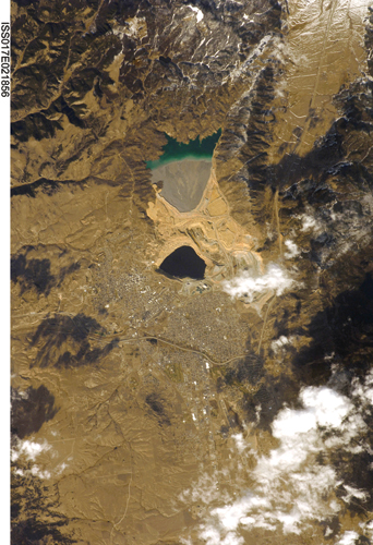 Overhead photo of the Berkeley Pit. Butte is immediately to the south and west; north of the Pit is Yankee Doodle Tailings Pond.