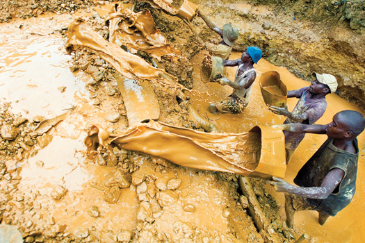 Water, already yellowed by cassiterite, is collected for sluicing
