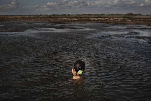 Seven-year-old Madina bathes in the Aral Sea near Tactubek.