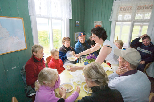 Soffía Vagnsdóttir, a matriarch in the Bolungarvík community, serves her mother Birna's famous Kjötsúp, a traditional and fortifying lamb and vegetable soup, in the dining area of her kitchen at Hesteryi.