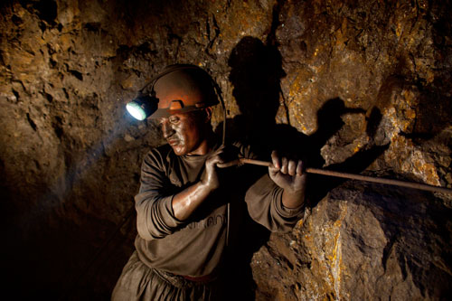 Santiago Qispe, twenty-nine, hollows out a hole for dynamite in Pairaviri, the largest mine in Potosí, Bolivia.