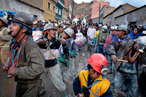 Miners march down from Cerro Rico into the city during the annual Miners' Carnival celebrating their history and culture.