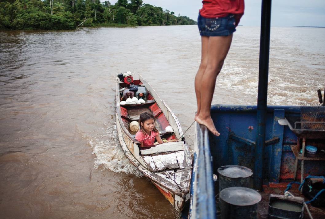 Alessandra, eighteen (right), and her niece Maria, eight, board the Matheus Pinto cargo ship to sell tapioca. Alessandra, whose mother is a prostitute, 
became a balseira when she was eight years old.