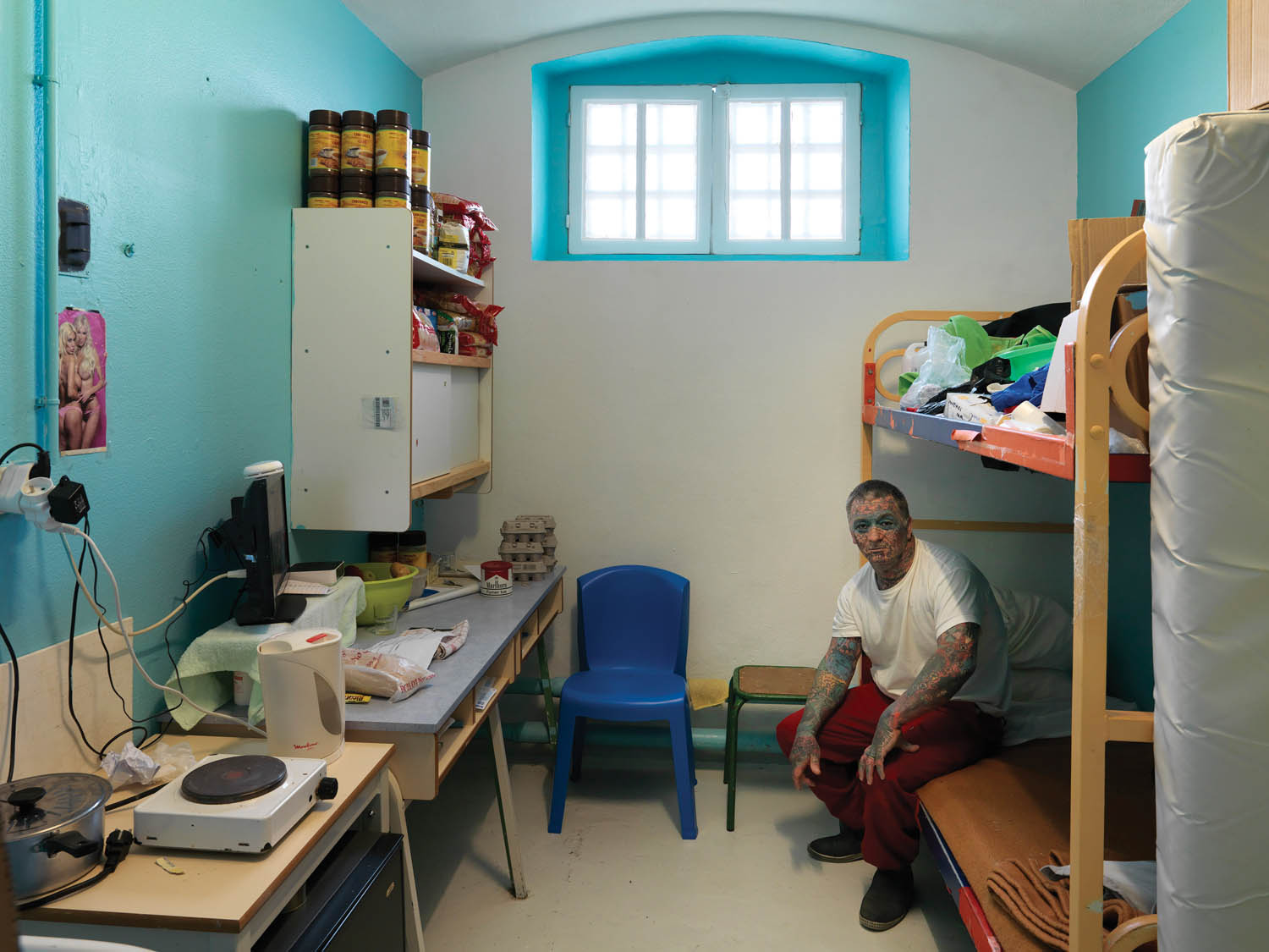 A prisoner in his cell in the Maison d’arrêt de Bois-d’Arcy. France, 2013. Photograph by Jan Banning.