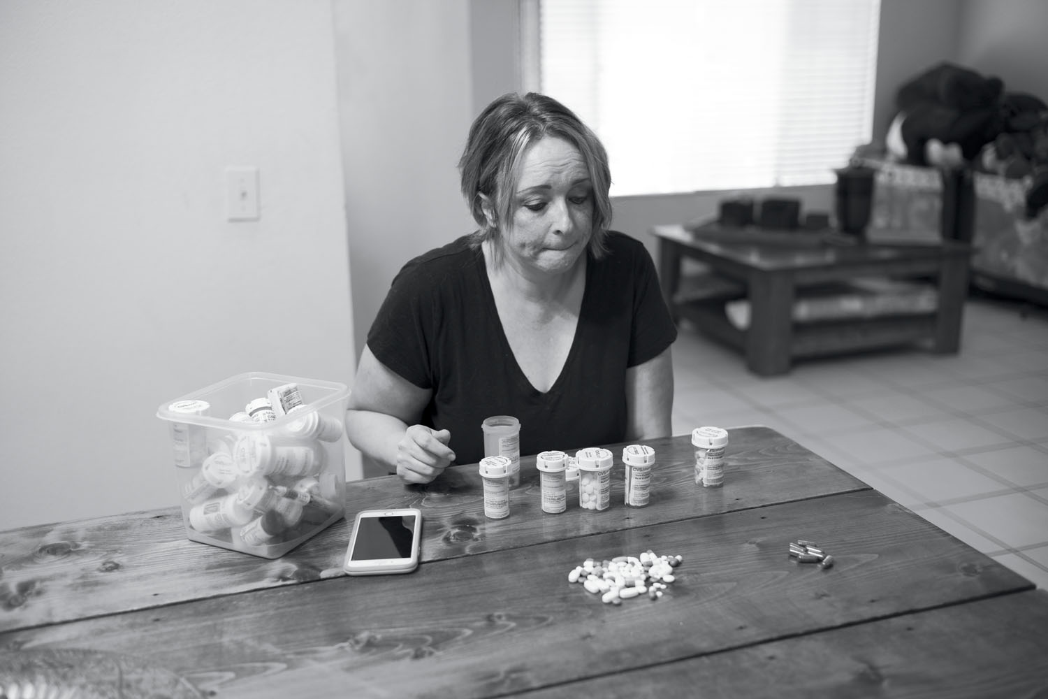 Jenni Mai with medications previously used to treat her sons, Nate and Dylan. Both boys have been diagnosed with severe autism spectrum disorder and Mai has been using cannabis for their treatment since 2017, when Nate’s violence toward her became a daily event. Over time, she weaned Nate off multiple pharmaceuticals in favor of cannabis. Mai helped found WPA4A, an advocacy and support group for families who use cannabis to treat children with autism. San Bernardino, CA, August 2018.