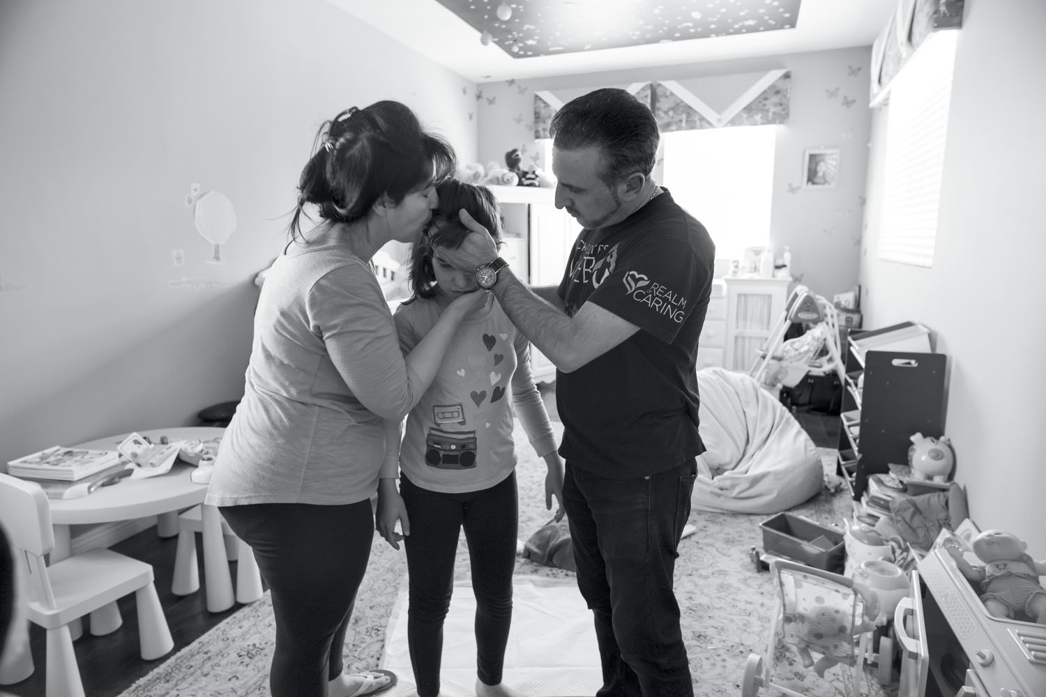 Ray Mirzabegian and Arsineh Yaghyaei attend to their daughter Emily as she recovers from a seizure. Los Angeles, CA, April 2018.