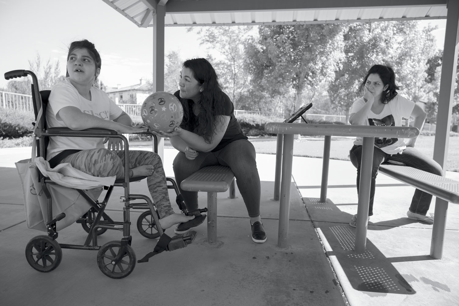 Emily at the park with her occupational therapist (center) and mother, Arsineh (right). Tujunga, CA, 2021.