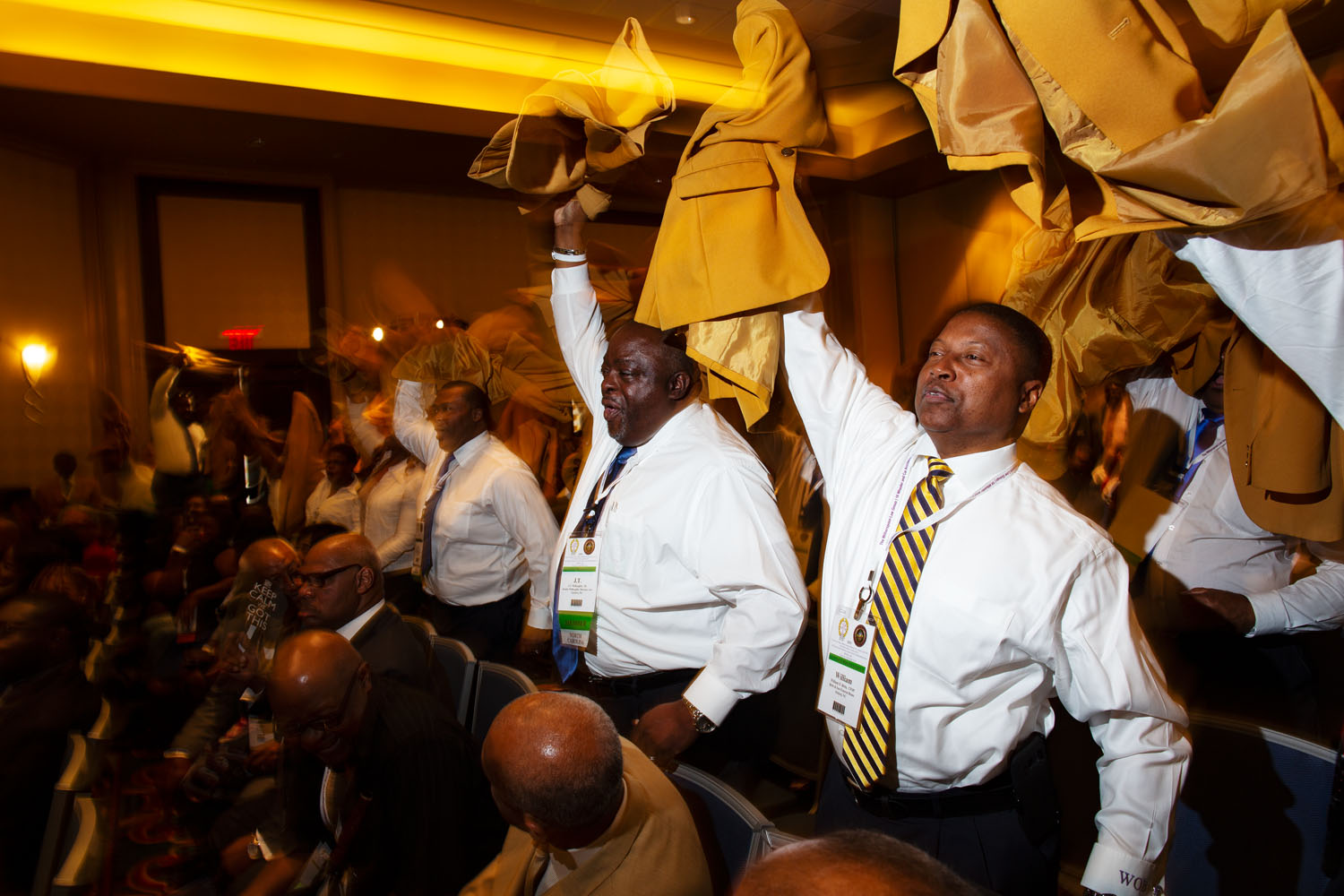 Members of the National Funeral Directors and Morticians Association from North Carolina wave their jackets and shout on cue when asked to show their spirit during NFDMA’s 82nd Annual National Convention and Exposition. Mobile, AL, August 2019.