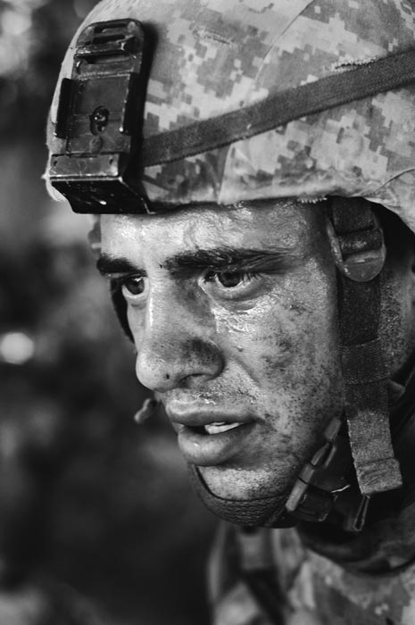 Out of breath, US Army Specialist Larry Bowen, twenty-six, sits shellshocked in a ditch after a frontal assault on an insurgent position in close-quarter fighting during an operation that lasted over several days in the Taliban stronghold of Siah Choy in Zhari District.