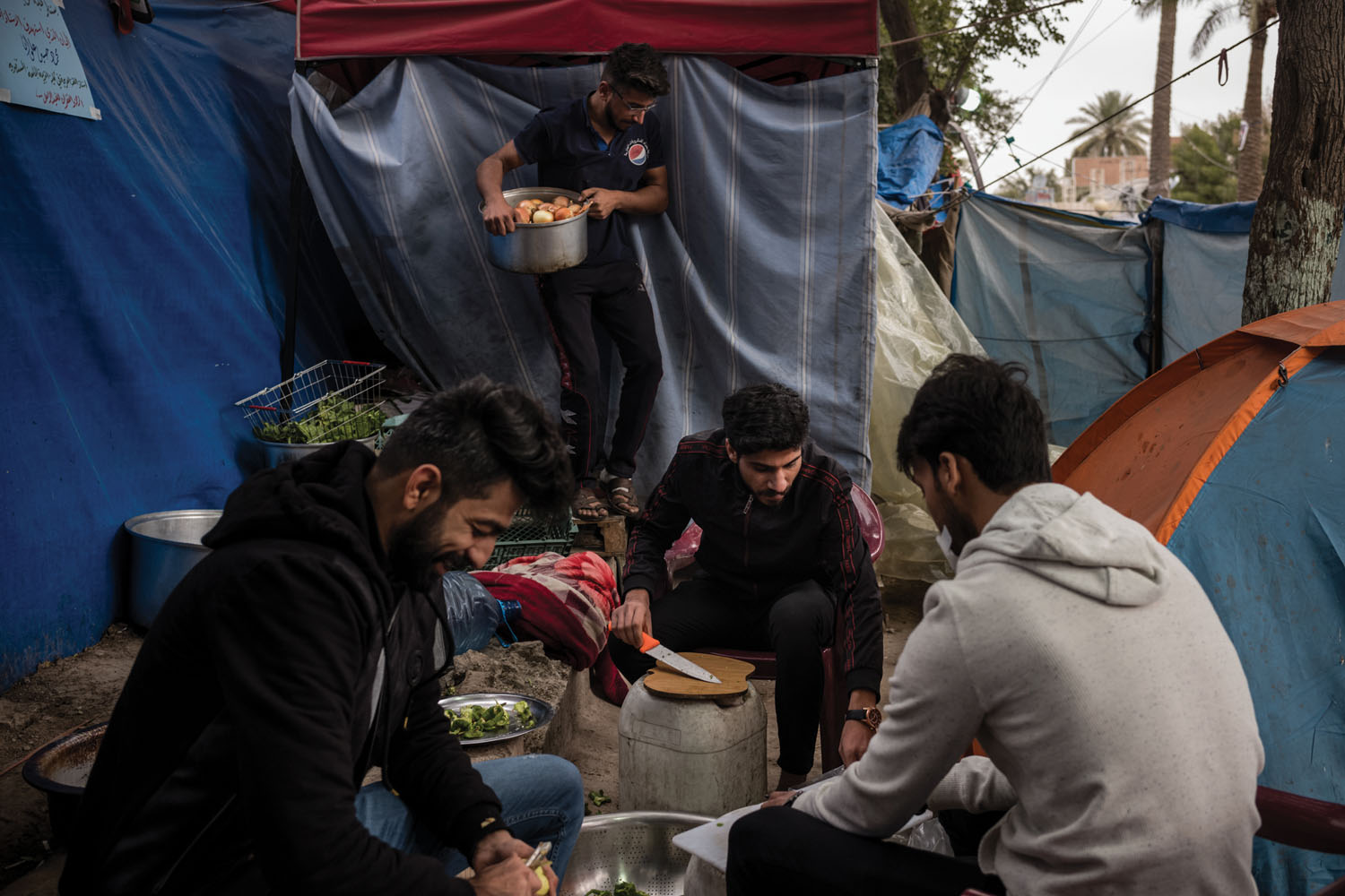Protesters prepare breakfast in an encampment.