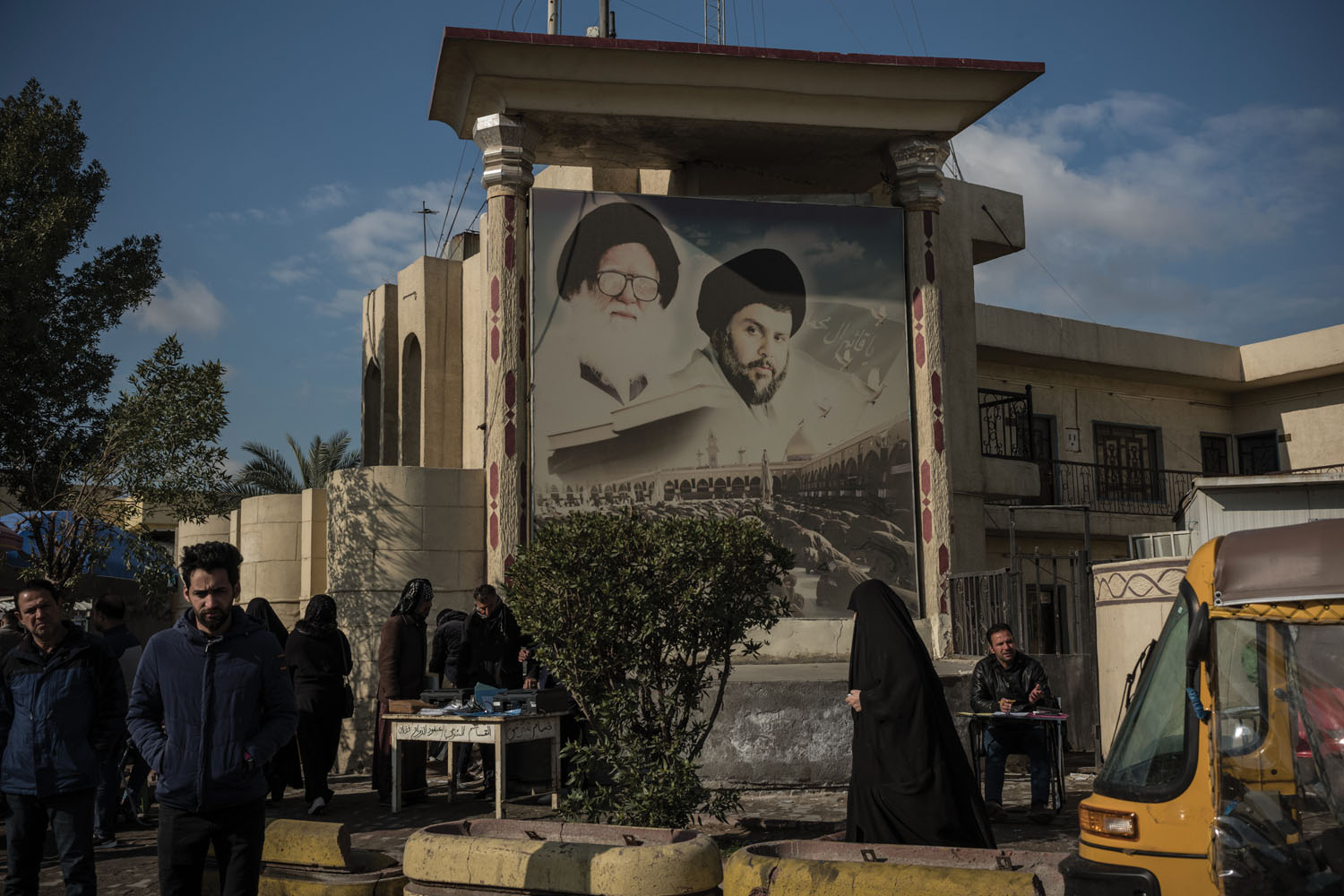 A billboard of Shia cleric Muqtada al-Sadr and his late father, Mohammed Sadeq al-Sadr, in Baghdad’s largest slum, Sadr City. Muqtada al-Sadr was an early supporter of the protesters, but his position has been inconsistent; many speculate that his recent critiques of the movement are the result of Iranian financial backing.