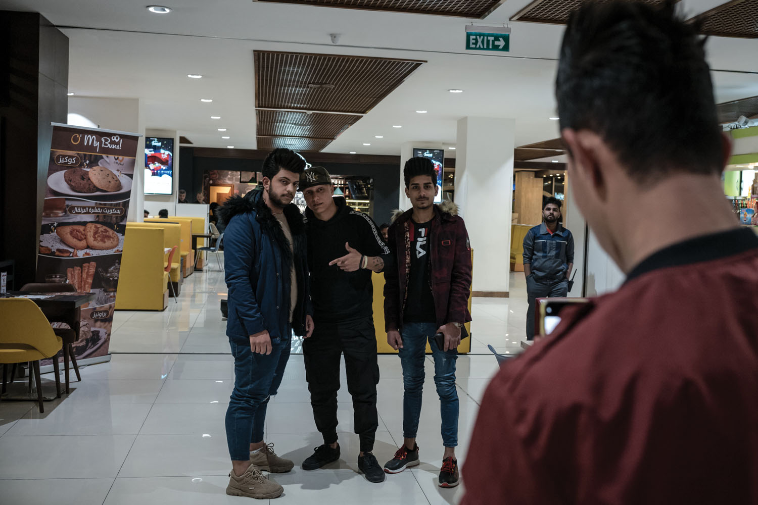 Saddam Abdulkarim (center), 27, a self-taught hip-hop dancer, poses for a photo with his fans in Babylon Mall.