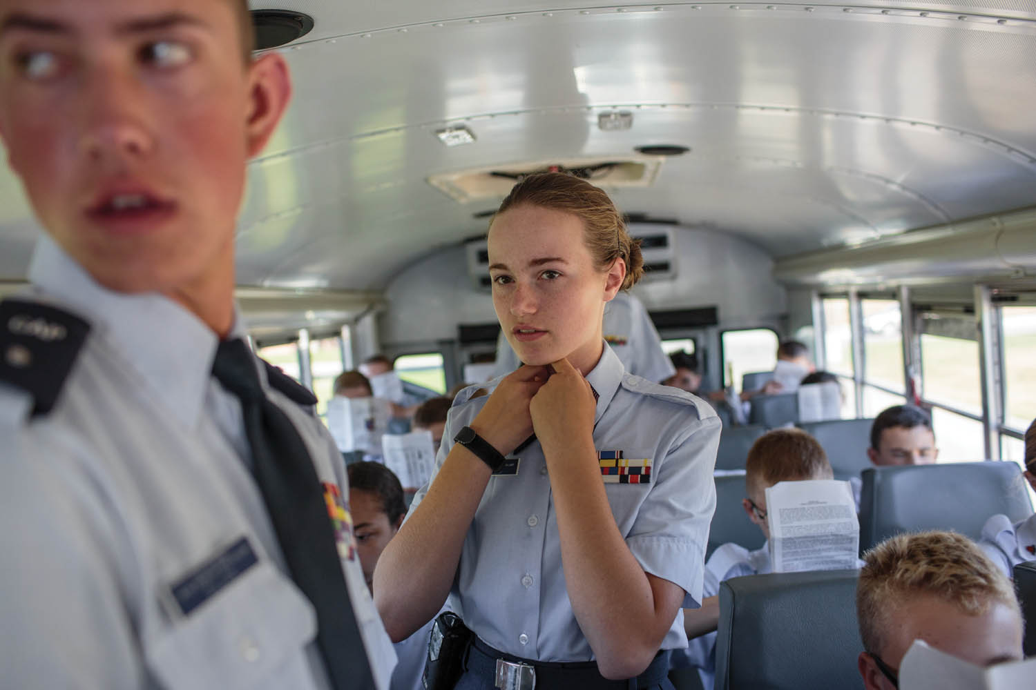 Kayla Wayman (center) is in charge of ensuring that all of the cadet students are in their seats and at attention before driving to the South Dakota Air and Space Museum, at Ellsworth Air Force Base, Rapid City, SD. Students from five states around the Midwest spend a week at the Civil Air Patrol Joint Dakota Cadet Encampment. Photographed by Sarah Blesener