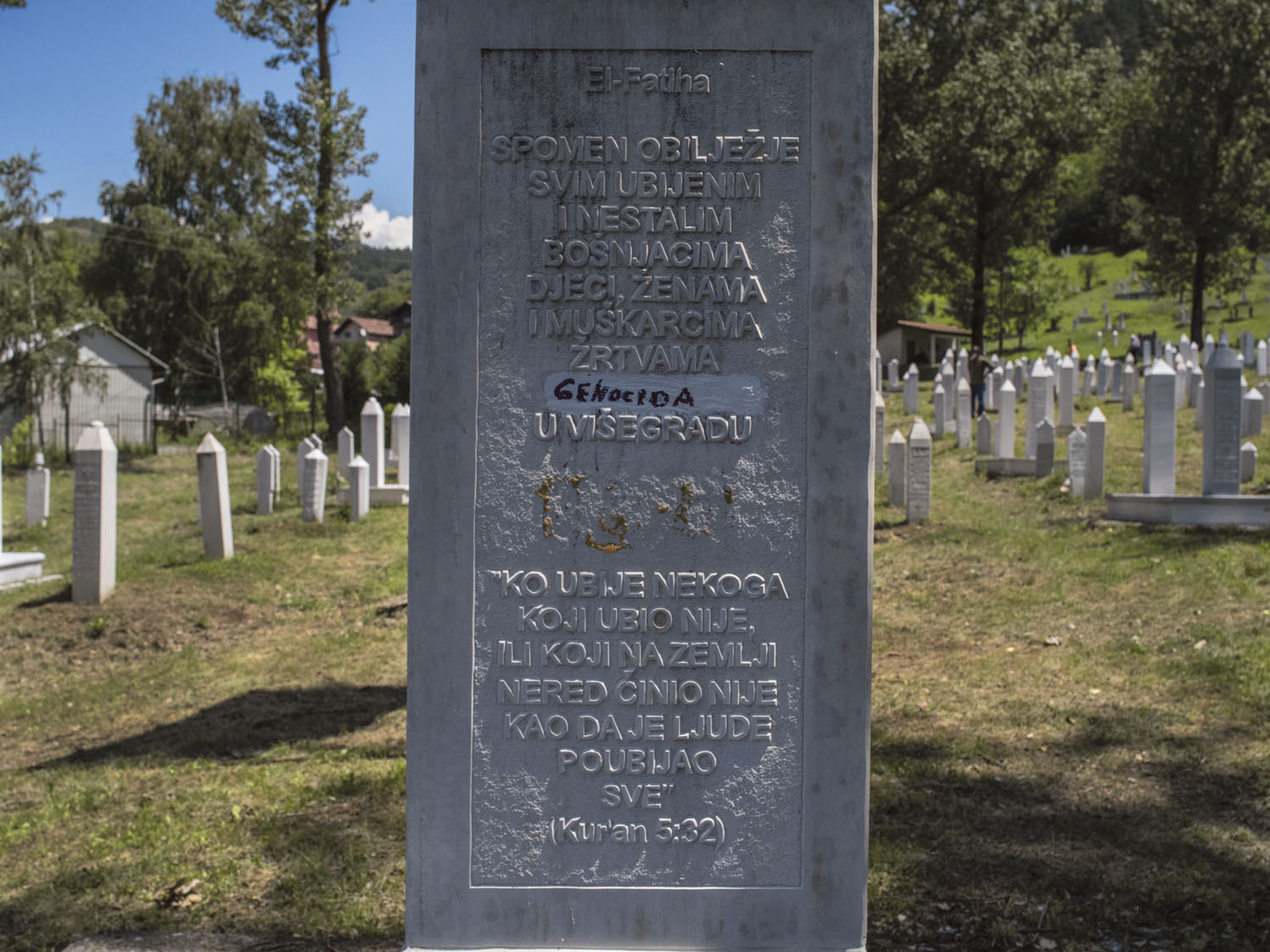 The word <i>genocide</i> written on a cenotaph at Stražište Cemetery during a genocide-commemoration ceremony. Višegrad, June 2020.