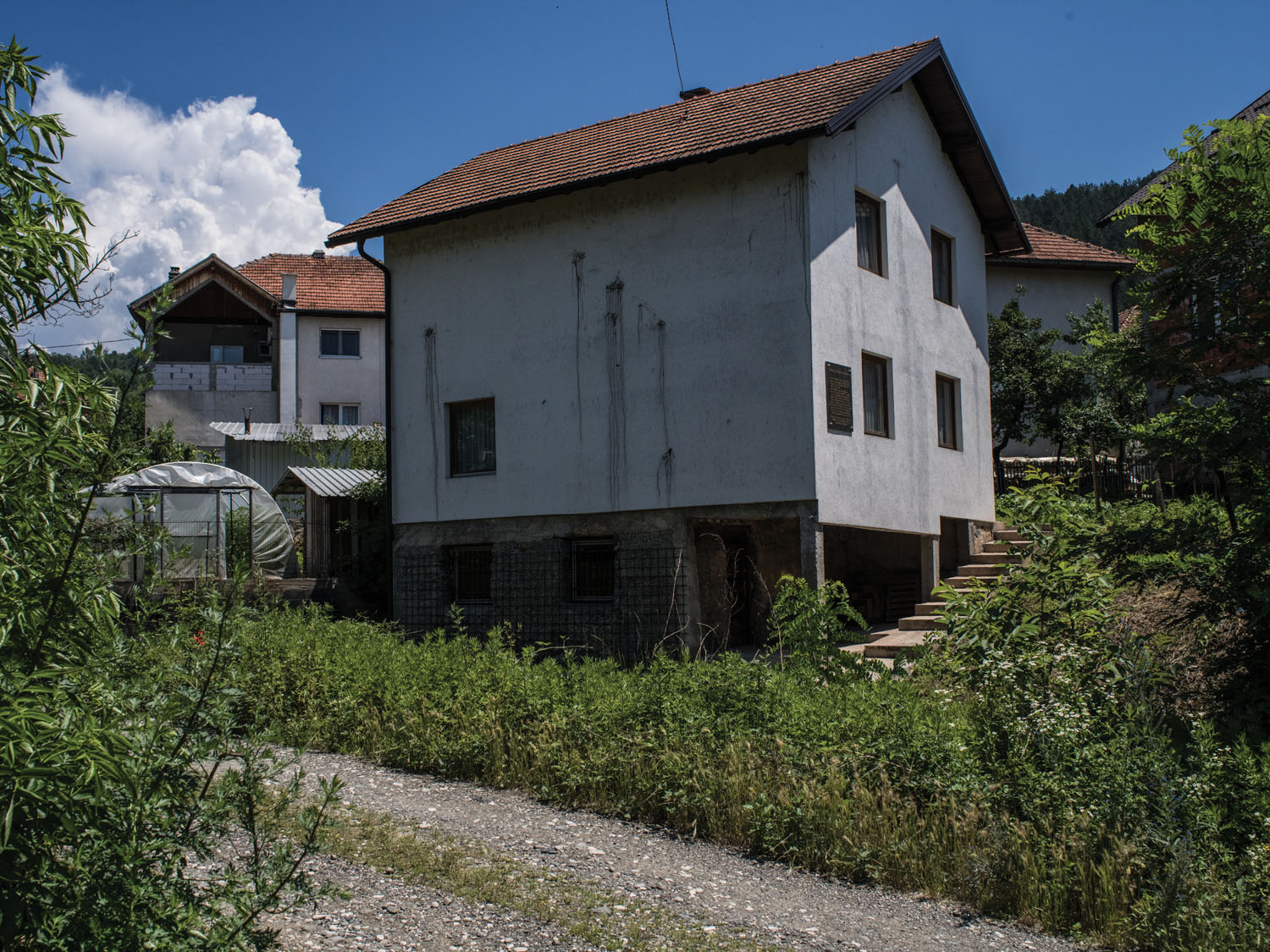 The house on Pionirska Street, where, in 1992, nearly sixty Bosniak prisoners were killed after Serb forces set the structure on fire.