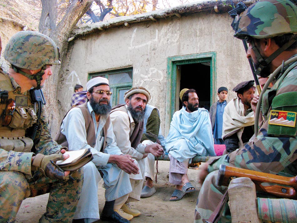 Village elders in the Watapur Valley explain their problems to a Marine lieutenant and soldiers of the Afghan National Army during an impromptu meeting.