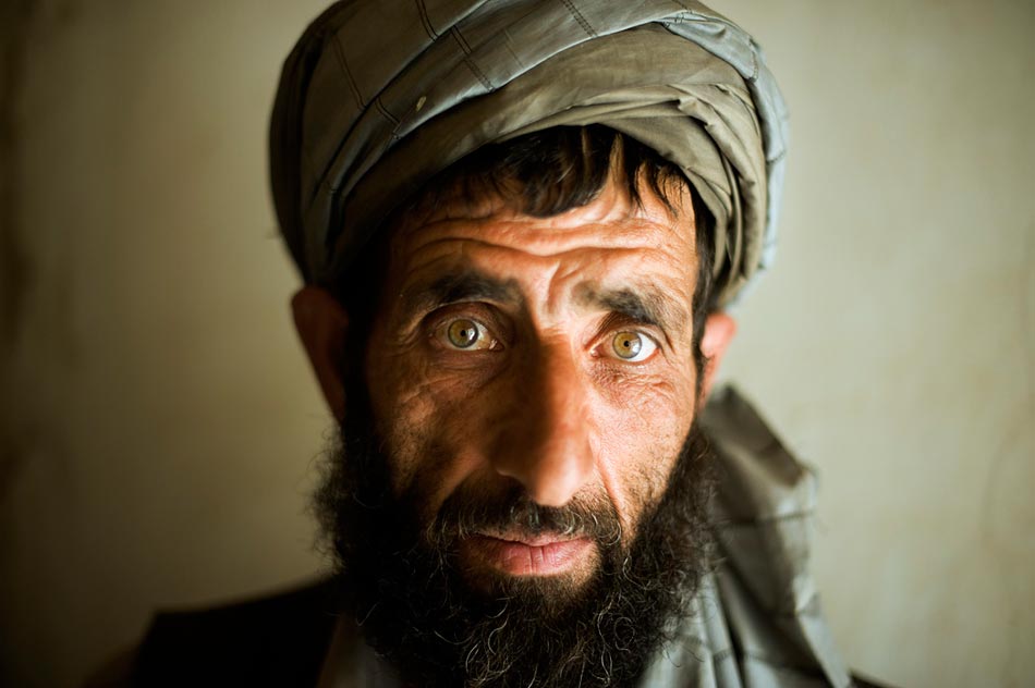 An Afghan civilian in his home in the Jalrez Valley, Wardak Province, while a joint patrol of Afghan National Police (ANP) and US Army soldiers search his property.