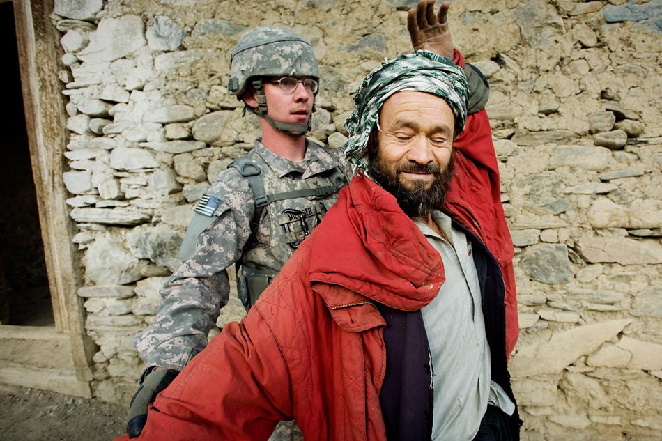 A US Navy Civil Affairs specialist searches an Afghan civilian in the Jalrez Valley, Wardak Province.