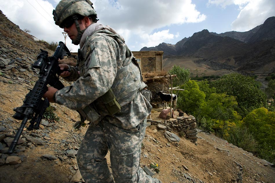 A US Army soldier from the 10th Mountain Division scales a steep valley wall in the Jalrez Valley, Wardak Province.