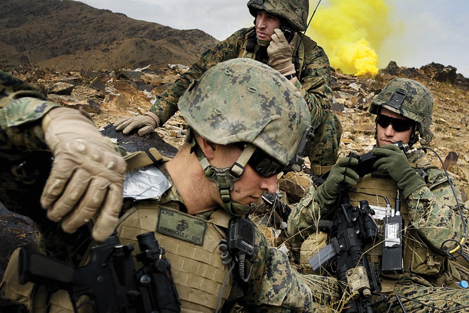 Marine Captain Maloney (far right) communicates with Army Special Forces and aircraft in the midst of a brief firefight with insurgents in the Depak Valley.