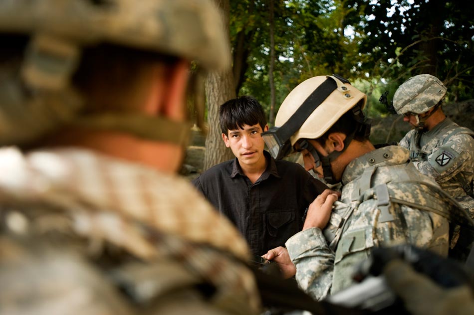 US Army soldiers from the 10th Mountain Division interrogate an Afghan boy in the Jalrez Valley, Wardak Province.