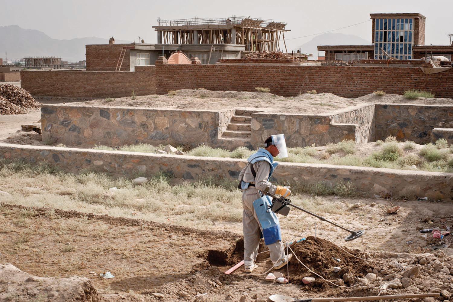 An Afghan de-miner painstakingly searches for landmines and unexploded ordnance in a new neighborhood next to Dar Ul Aman Palace. More than twenty years after the Soviet withdrawal, there are still over 100 minefields in the greater Kabul area, which was the most heavily mined region during the Soviet occupation and the ensuing civil war. Over 400 Afghans—mostly children—are still wounded each year by landmines and explosive remnants of war. De-mining programs employ 14,000 Afghans and cost the internationa