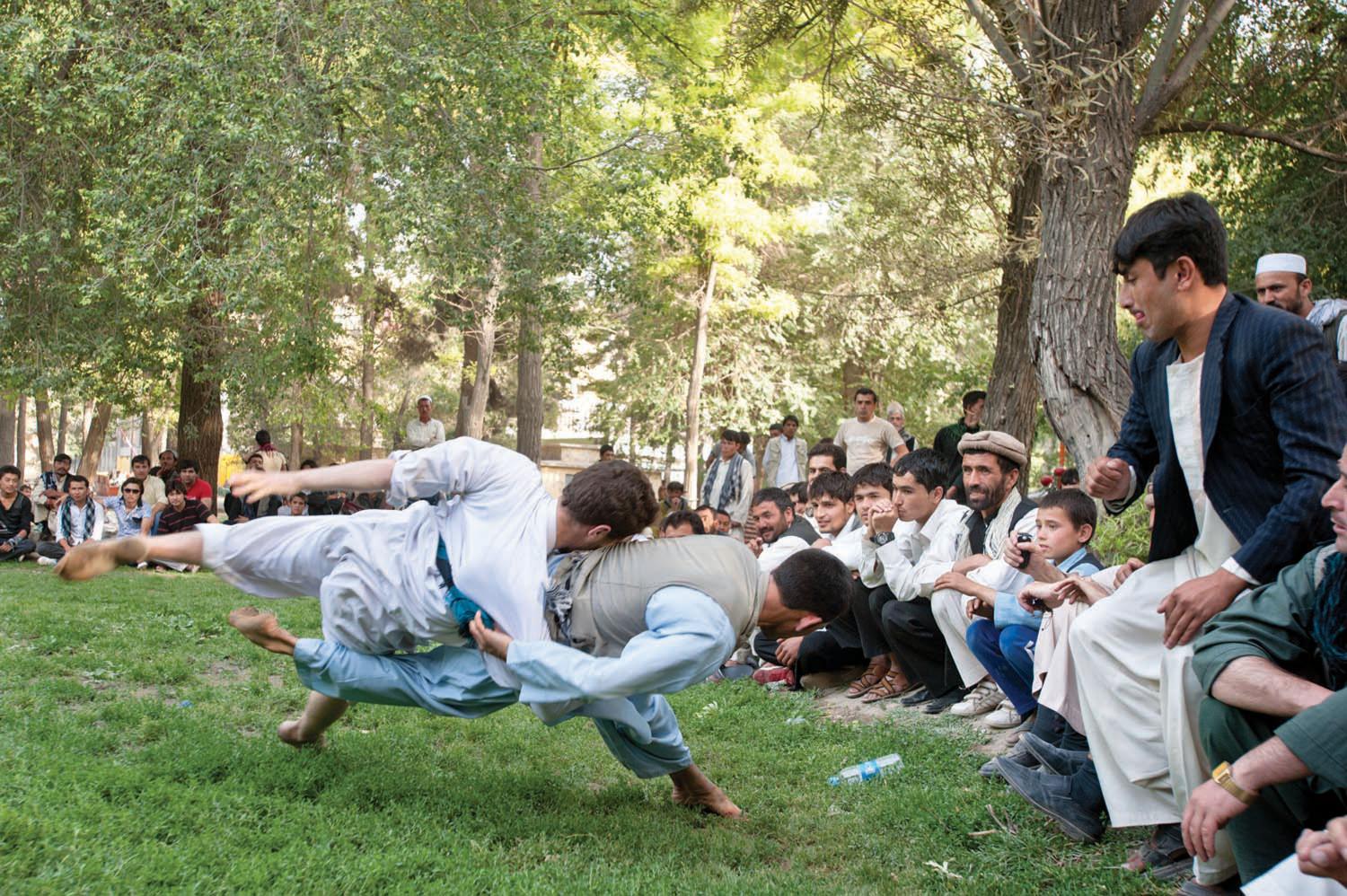 Men gamble on a Karate match in Shar-e-Now Park, in downtown Kabul. Under the Taliban government, activities involving gambling and most forms of play were strictly forbidden, including favorite pastimes like bird and dog fighting.