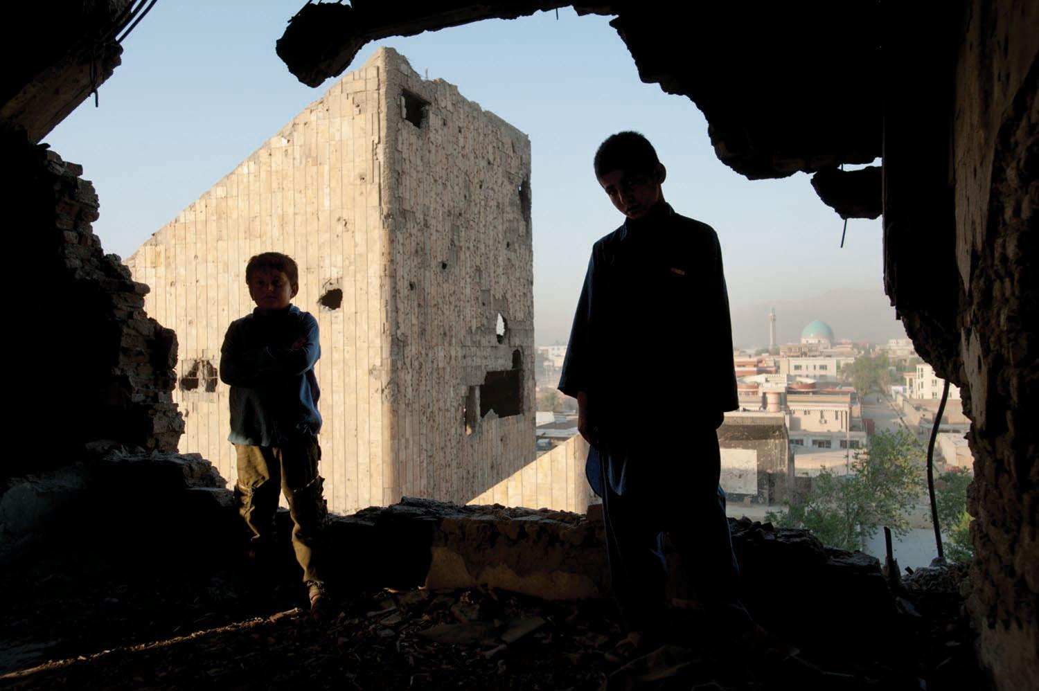 Sherifullah, eleven, and Abdel Basit, eight, stand on one of the upper floors of the Russian Palace of Culture, which was heavily shelled during the mujahidin civil war that followed the Soviet withdrawal. Until recently, the bombed out buildings sheltered homeless Afghans and heroin addicts. Efforts by the Russian government to rehabilitate the cultural center are underway.