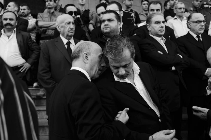 Lebanese security officials conferring during al Hassan’s funeral. From Alex Potter's "After the Funeral."