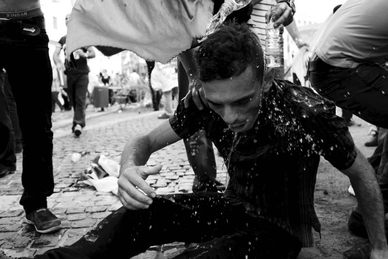 A young man is doused with water after passing out from tear gas. From Alex Potter's "After the Funeral."