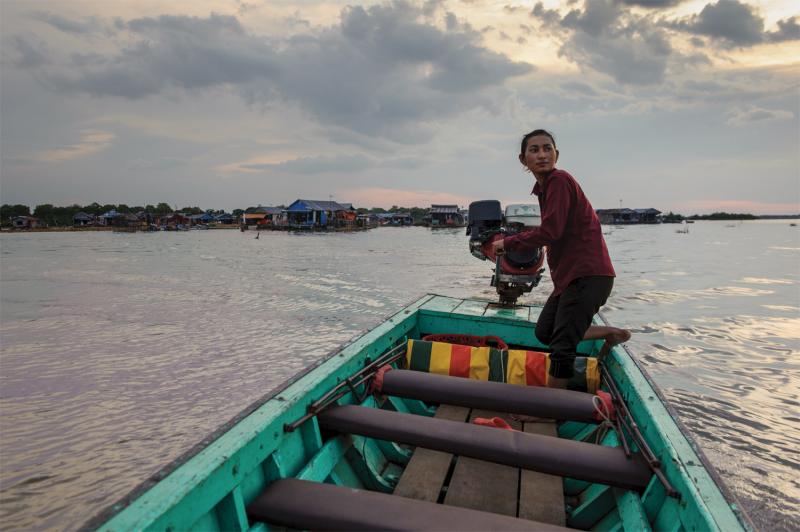 A water-taxi driver crosses the Tonle Sap lake, heading toward the mainland from the floating  village of Akol. (Luc Forsyth/Ruom)
