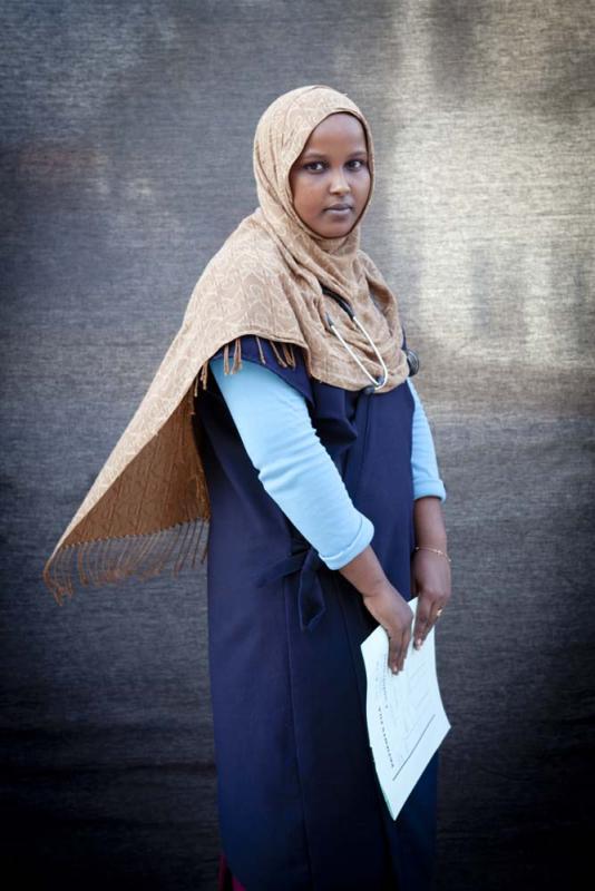 Ayan Muhyadin, 19, Nurse — I was born in war, I work in war, and I live in war. At the clinic I mainly treat gunshot wounds and urinary tract infections. When I leave the clinic, I cover myself up, leav- ing only my eyes visible. I don’t want al Shabaab to target me because I work for the government. In my free time I like to get on Facebook, read Tom and Jerry comics, and watch TV. “Prison Break” is my favorite show.