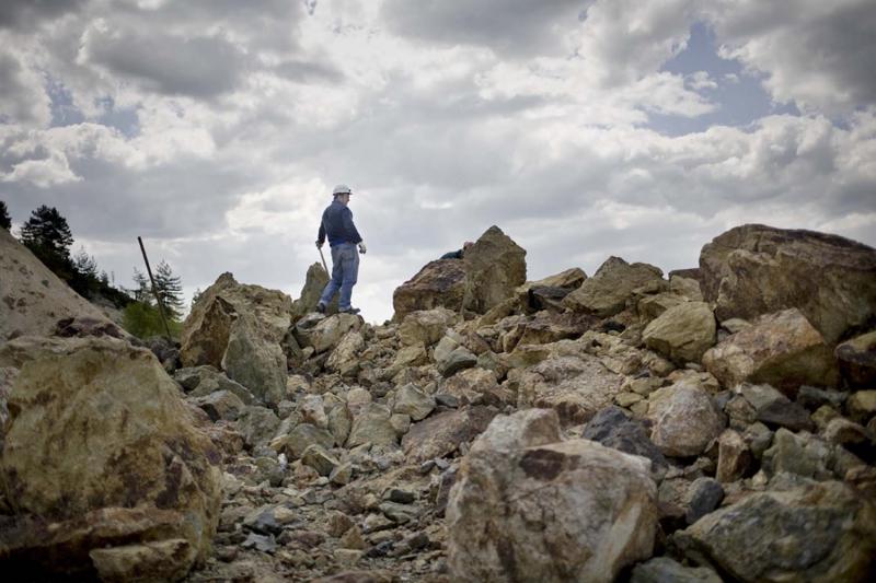 A geologist employed by the Rosia Montana Gold Corporation stands amid the mine’s waste-rock rubble. The company has proposed four new open-pit mines, which would generate 200 million tons of waste rock—and bury the nearby village.