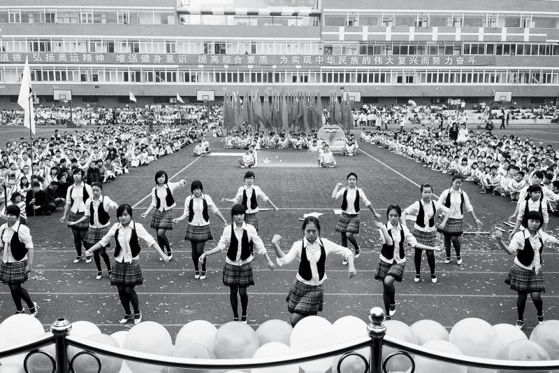 Students compete in the annual two-day sports-meeting opening parade dance contest, which is judged by the headmaster. From Yuyang Liu's "Home of Youth."