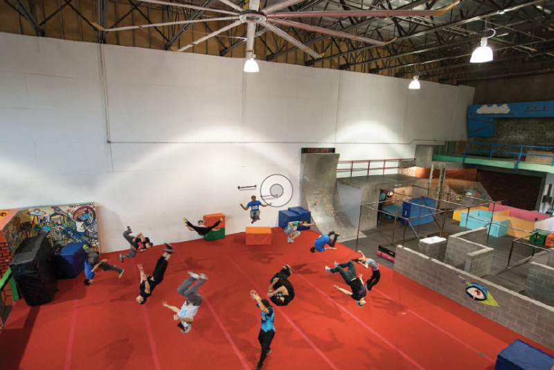 Team Tempest practices a coordinated flip at its warehouse training facility. Most members compete in free-running competitions in between performing stunts for films and commercials. 