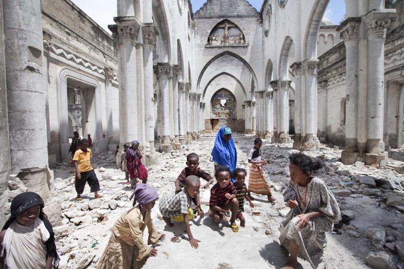 Children from Al-Adala, a nearby IDP camp, play in Mogadishu Catholic Cathedral, destroyed by Islamists in 2008. 