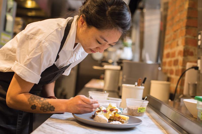 Chou on the line at Mourad, preparing a walnut genoise, 2015. (James Hall)