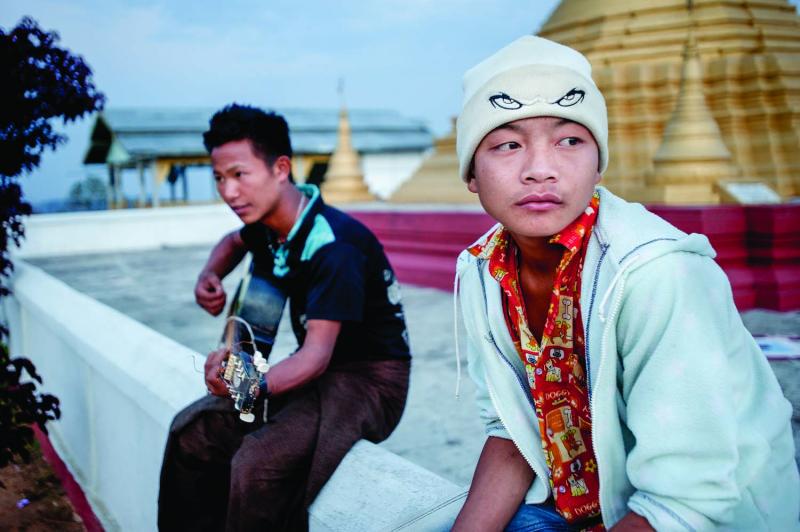 Teenage boys hang out at the pagoda above Layshee, modeled after the famous Shwedagon Pagoda in Yangon.