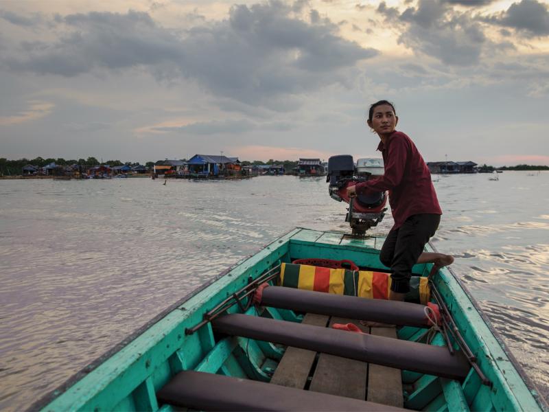 A water-taxi driver crosses the Tonle Sap lake, heading toward the mainland from the floating  village of Akol. (Luc Forsyth/Ruom)