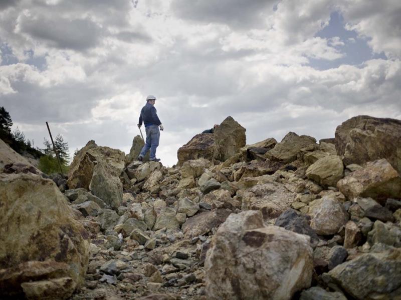 A geologist employed by the Rosia Montana Gold Corporation stands amid the mine’s waste-rock rubble. The company has proposed four new open-pit mines, which would generate 200 million tons of waste rock—and bury the nearby village.