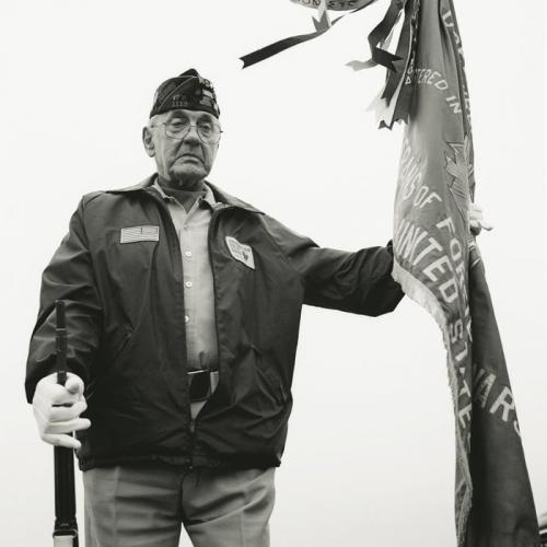 A World War II veteran holds a flag during a service at the Cavalry Cemetery in Eveleth, Minnesota, on Memorial Day, May 26, 2008. Noah Pierce, who is buried there, returned after two tours of Iraq with severe PTSD and committed suicide near his family home on July 26, 2007 (ASHLEY GILBERTSON).